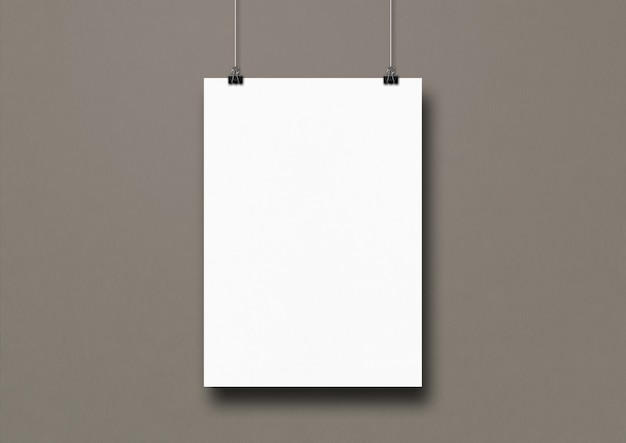 Photo white poster hanging on a grey wall with clips.