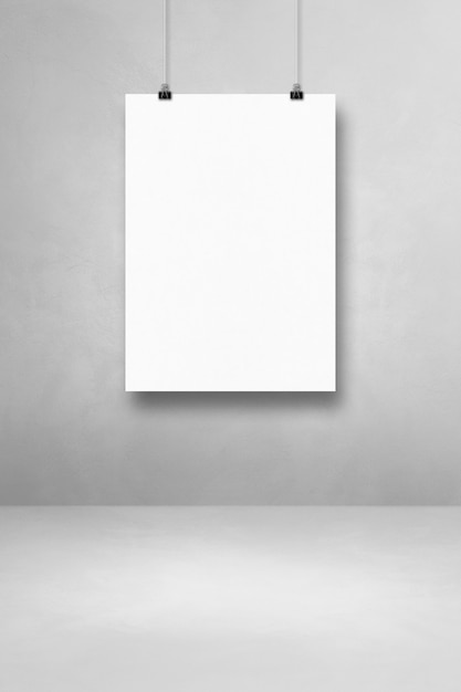 Photo white poster hanging on a light concrete wall with clips. blank mockup template