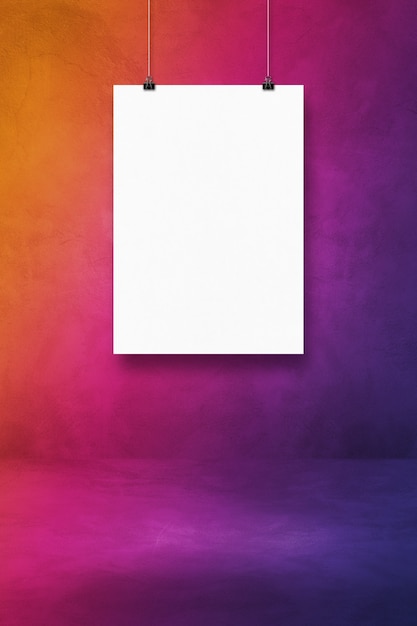 White poster hanging on a purple wall with clips. Blank mockup template