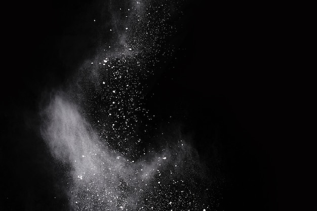 White powder explosion on black background. Colored cloud. Colorful dust explode. 