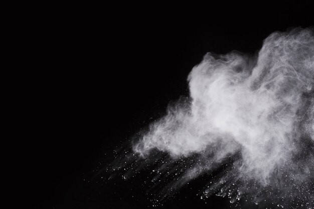 White powder explosion on black background. Colored cloud. Colorful dust explode. 