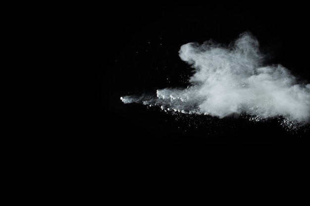 White powder explosion on black background. Colored cloud. Colorful dust explode. 