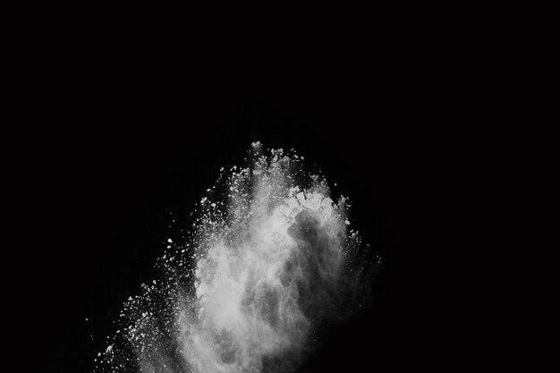 White powder explosion on black background. Colored cloud. Colorful dust explode. 