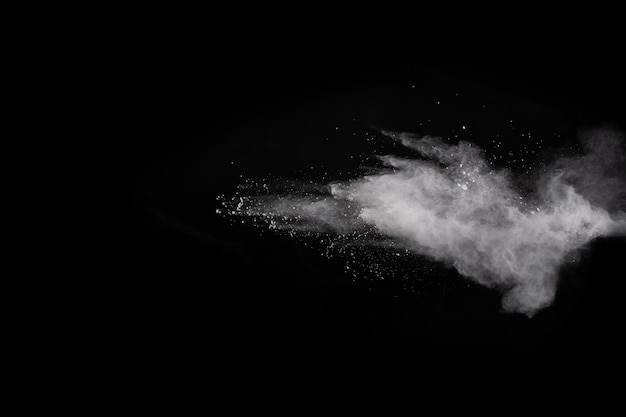 White powder explosion on black background. Colored cloud. Colorful dust explode.