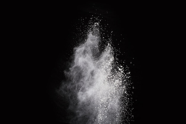 White powder explosion on black background. Colored cloud. Colorful dust explode. 