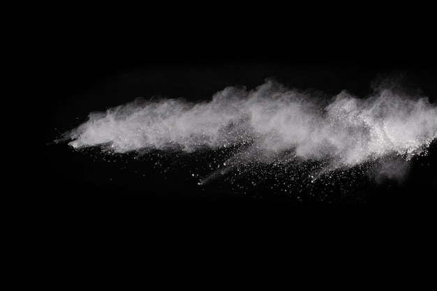 White powder explosion on black background. Colored cloud. Colorful dust explode. 