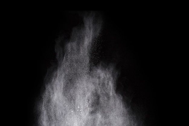 Photo white powder explosion on black background. colored cloud. colorful dust explode.