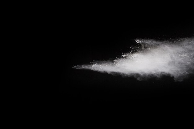 White powder explosion on black background. Colored cloud. Colorful dust explode. 