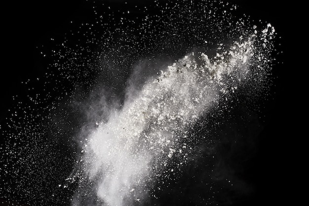 White powder explosion on black background. Colored cloud. Colorful dust explode. 