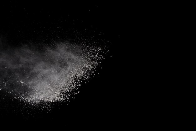 White powder explosion on black background. Colored cloud.  