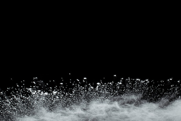 Photo white powder explosion on black background.