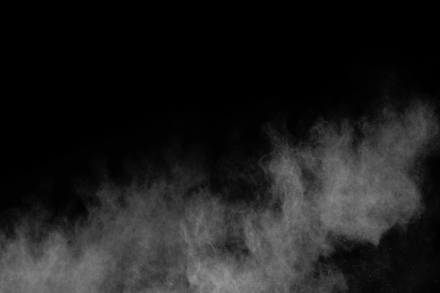 Photo white powder explosion on black background.