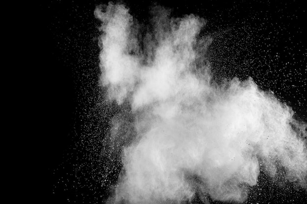 White powder explosion isolated on black background. White dust particles splash.Color Holi Festival.