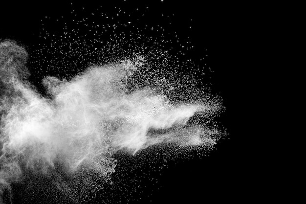 White powder explosion isolated on black background.White dust particles splash.