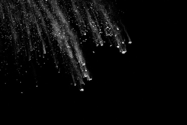 White powder explosion isolated on black background.White dust particles splash.