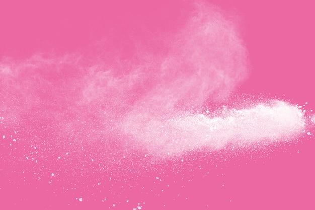 White powder explosion on pink background.