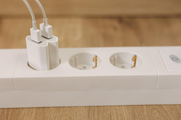 A white power strip with a plug in it