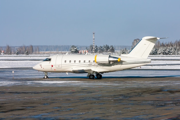 White private plane in a cold winter airport