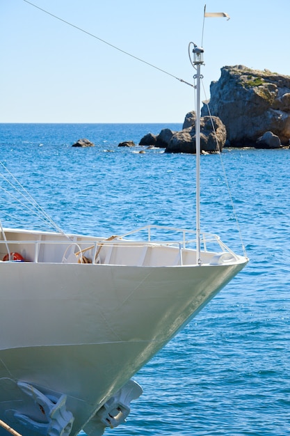 White prow of excursion tourist yacht  and sea water surface behind