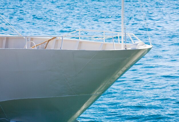 White prow of excursion tourist yacht  and sea water surface behind