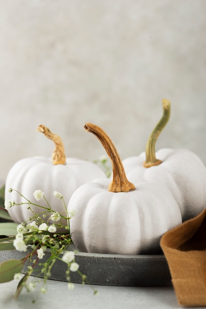 White pumpkins, cloth and leaves arrangement