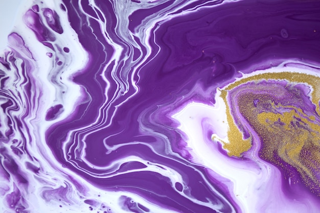 White and purple colors flow down and mix with each other abstract ink background