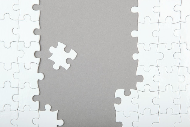 White puzzle on a colored background top view