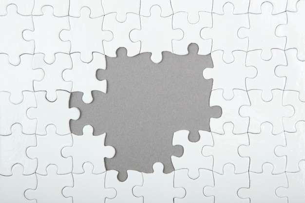 White puzzle on a colored background top view