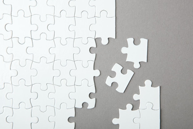 White puzzle on a colored background top view