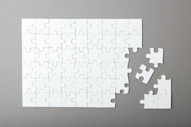 White puzzle on a colored background top view