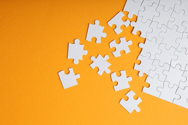 White puzzle on a colored background top view