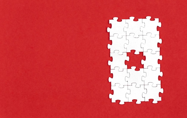 White puzzles on a red background flat lay