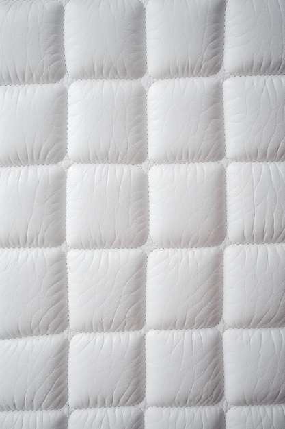 a white quilted quilted background with a pattern of a square