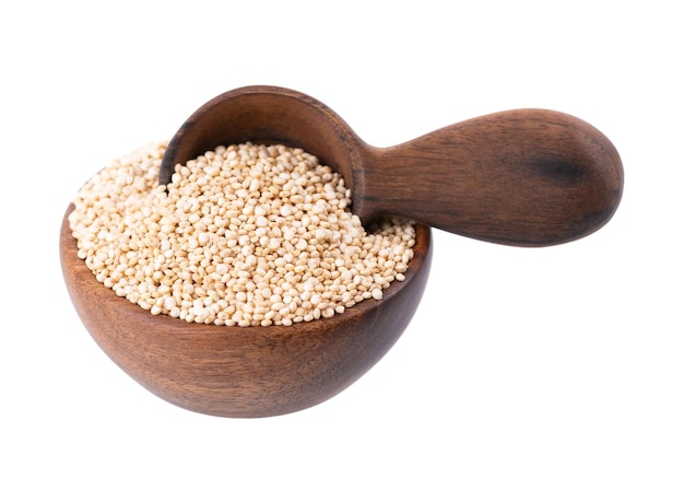 White quinoa seeds in wooden bowl and spoon isolated on white background Pile of raw kinwa