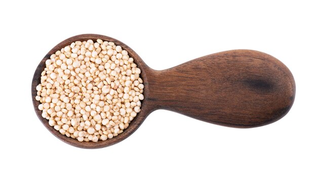 White quinoa seeds in wooden spoon isolated on white background Pile of raw kinwa Top view