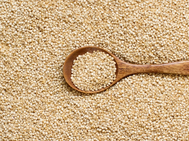 white quinoa with a wooden spoon close up