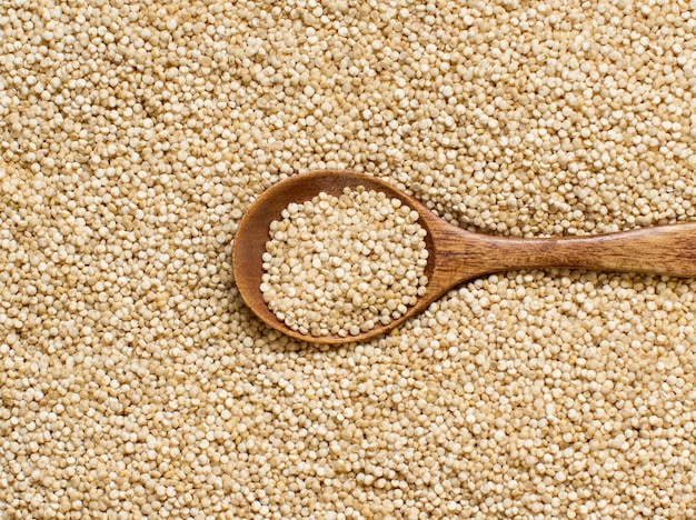 Quinoa bianca con un cucchiaio di legno da vicino