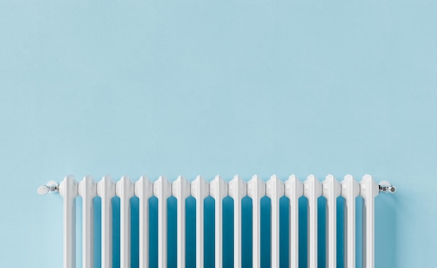 White radiator on blue wall