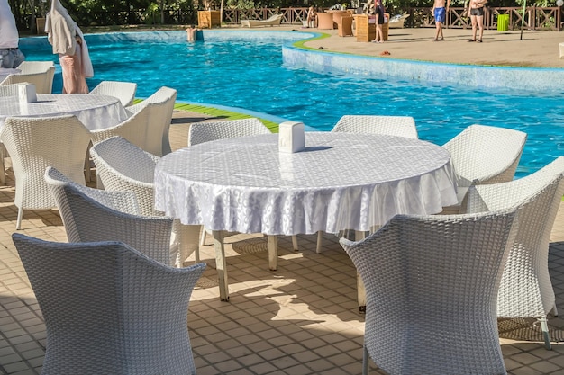 White rattan furniture near the pool