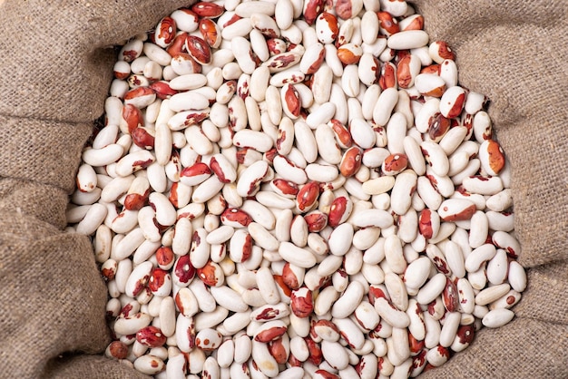 White and red beans in linen bag