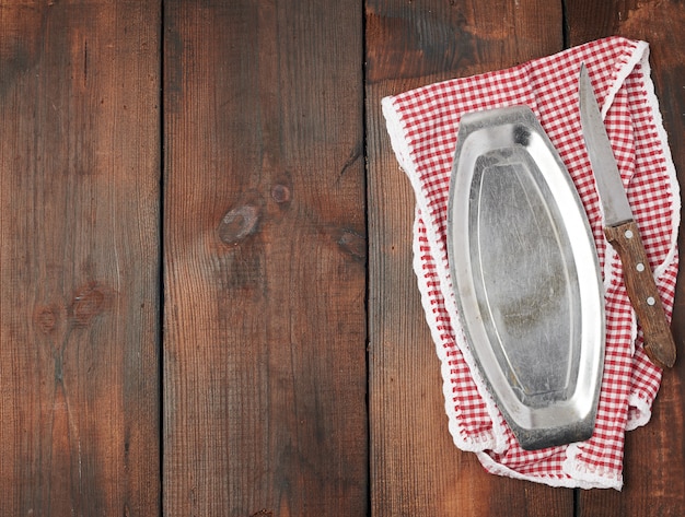 White red checkered kitchen towel, iron plate and sharp vintage knife