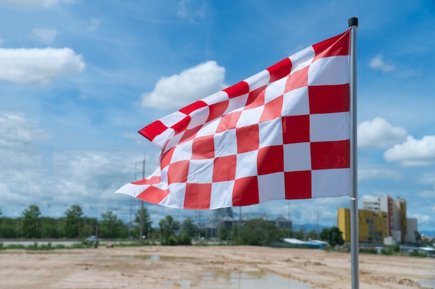 The white-red chess flag on the racetrack