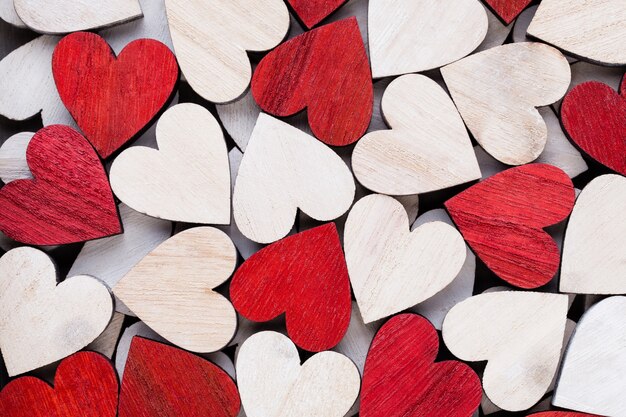 White and red hearts, background with wooden hearts.