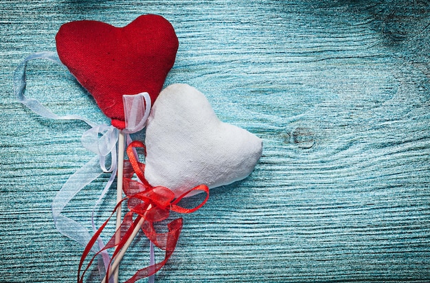 White red hearts with tapes on wooden board holidays concept