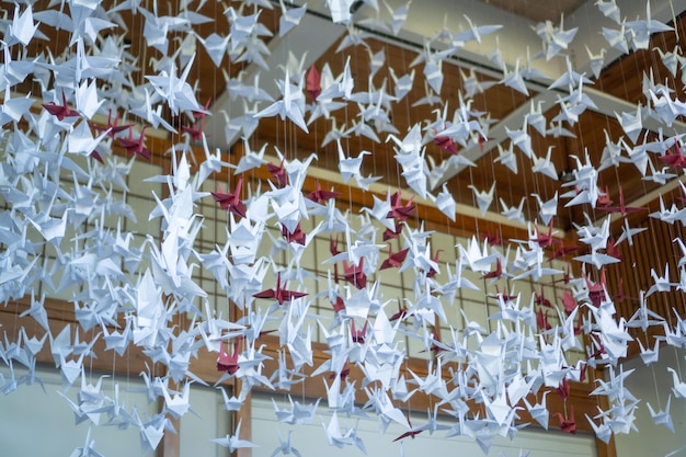 White and red origami hanging from the ceiling