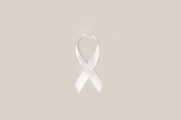 Photo white ribbon on a gray background with copy space