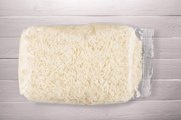 White rice in transparent plastic vacuum sealed bag .