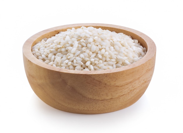 White rice in wood bowl isolated