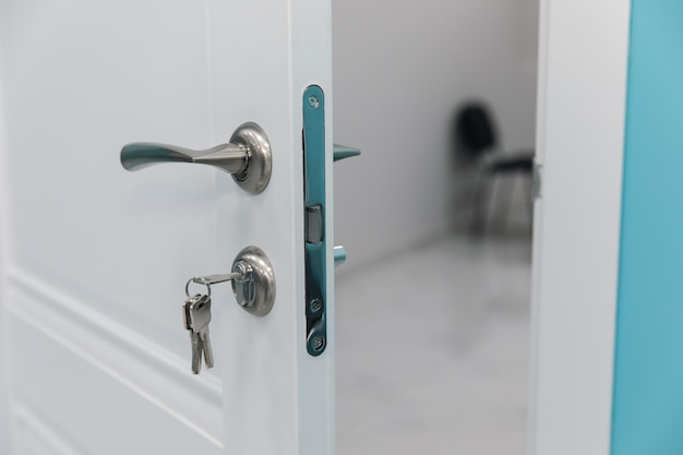 White room door with handle and key