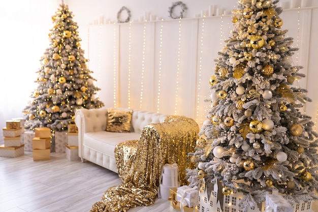 White room interior with new year tree decorated present boxes and white sofa colden colors